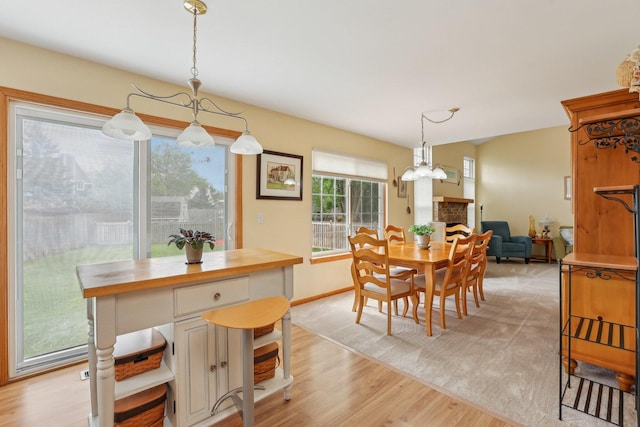 1011 Blackburn Dr, Grayslake, IL 60030 - dining room with light wood finished floors, a chandelier, and baseboards