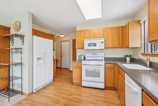 1011 Blackburn Dr, Grayslake, IL 60030 - kitchen with white appliances, a sink, light wood-style flooring, and dark countertops