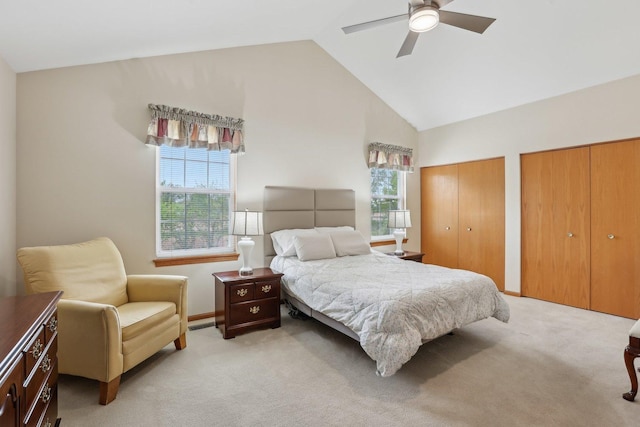 1011 Blackburn Dr, Grayslake, IL 60030 - bedroom featuring multiple windows, two closets, light carpet, high vaulted ceiling, and a ceiling fan