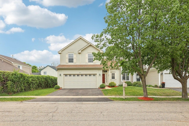1011 Blackburn Dr, Grayslake, IL 60030 - traditional-style home featuring asphalt driveway, a garage, and a front lawn