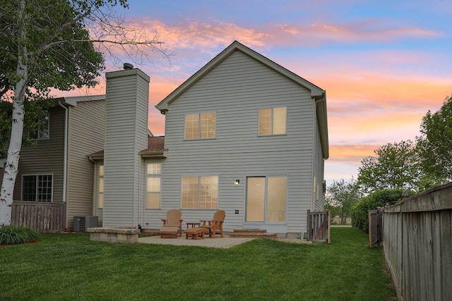1011 Blackburn Dr, Grayslake, IL 60030 - back of house at dusk featuring a patio area, a chimney, and cooling unit
