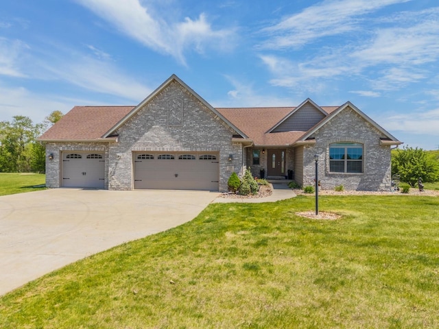 view of front of property with an attached garage, concrete driveway, a front yard, and a shingled roof