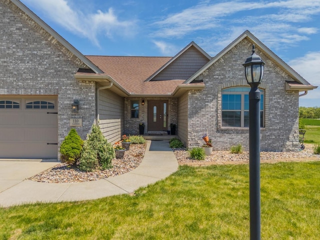 view of front facade with a front lawn, a garage, brick siding, and a shingled roof