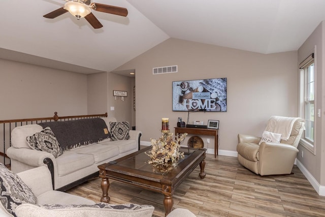 living room featuring wood finished floors, a ceiling fan, lofted ceiling, and baseboards