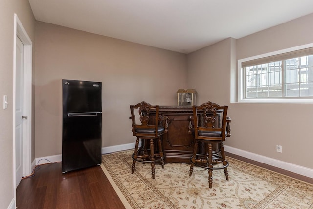 dining area featuring wood finished floors and baseboards