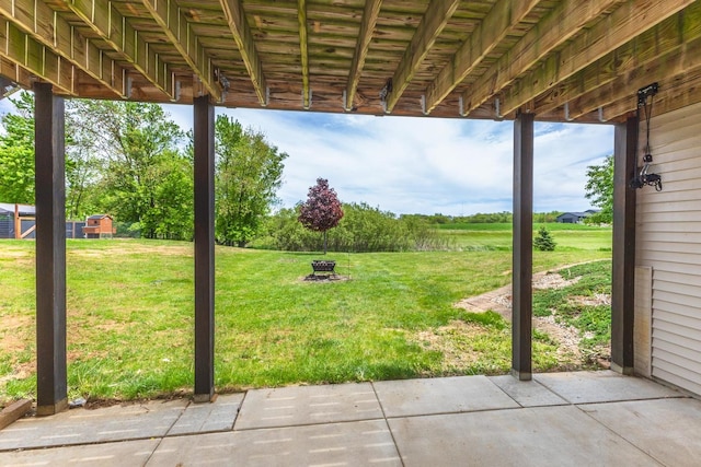 view of green lawn featuring a patio