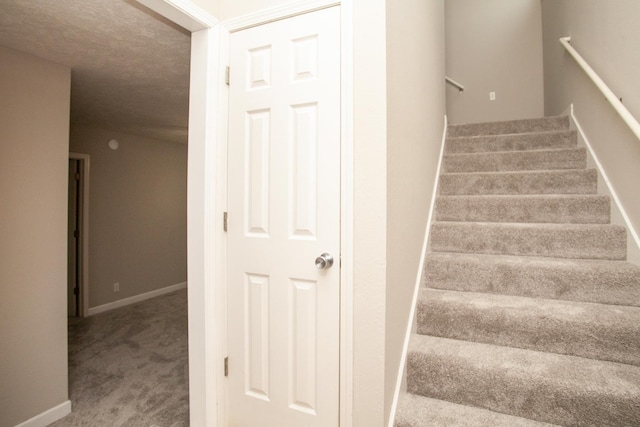 staircase with carpet floors and baseboards