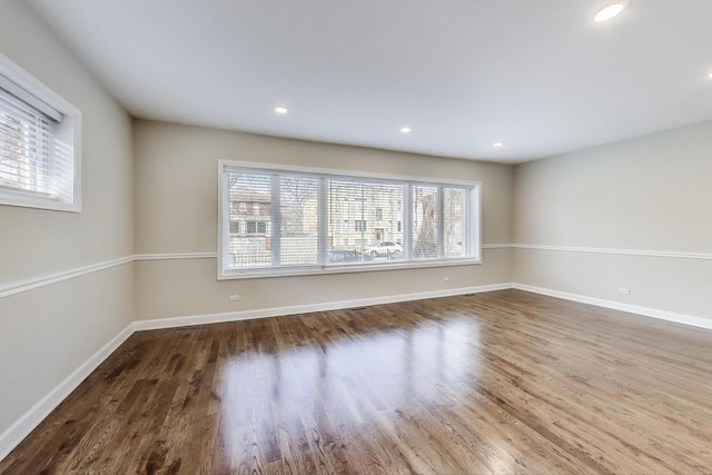 7955 S Paxton Ave, Chicago, IL 60617 - spare room with recessed lighting, baseboards, a wealth of natural light, and wood finished floors