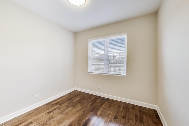 7955 S Paxton Ave, Chicago, IL 60617 - spare room featuring baseboards, dark wood finished floors, and visible vents