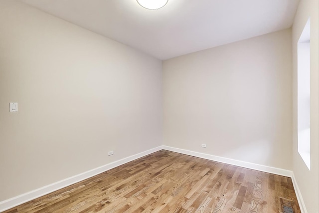 7955 S Paxton Ave, Chicago, IL 60617 - empty room with light wood-style floors, baseboards, and visible vents