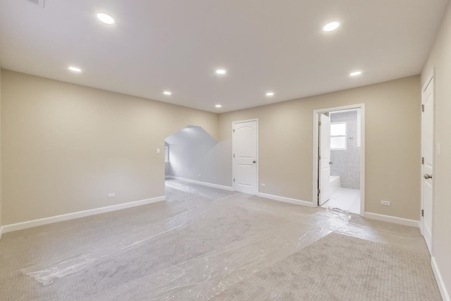 7955 S Paxton Ave, Chicago, IL 60617 - empty room with arched walkways, baseboards, recessed lighting, and light colored carpet