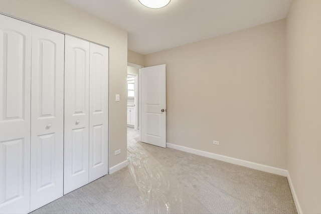 7955 S Paxton Ave, Chicago, IL 60617 - unfurnished bedroom featuring baseboards, light carpet, and a closet
