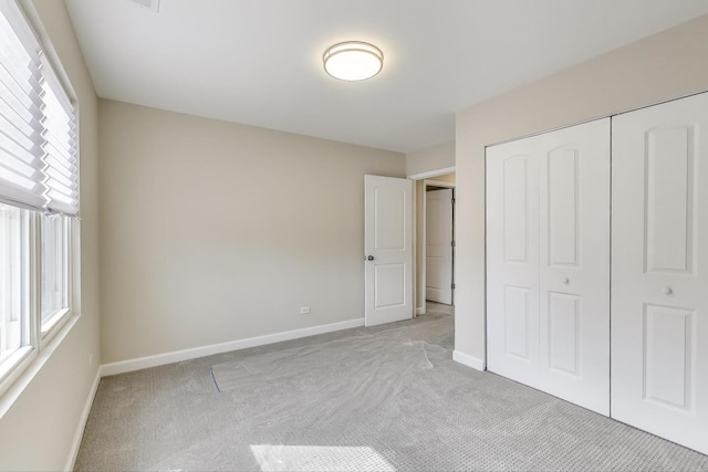 7955 S Paxton Ave, Chicago, IL 60617 - unfurnished bedroom featuring baseboards, light carpet, and a closet