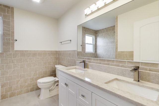 7955 S Paxton Ave, Chicago, IL 60617 - full bathroom with a sink, tile patterned floors, toilet, and tile walls
