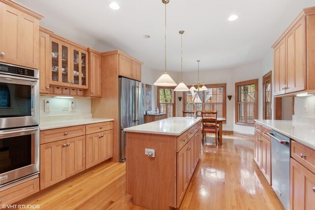 kitchen with appliances with stainless steel finishes, light wood-style flooring, and light brown cabinetry
