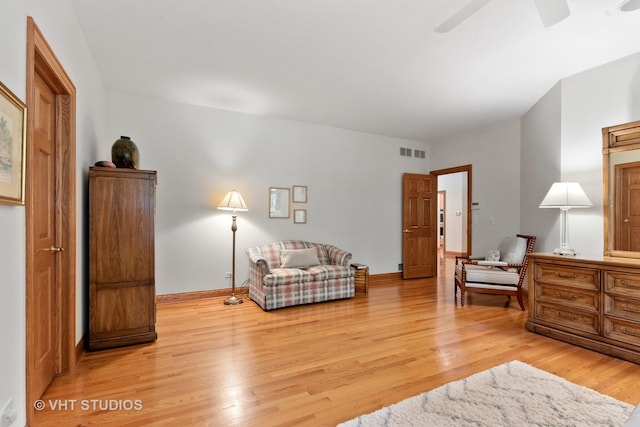 living area featuring ceiling fan, baseboards, light wood-type flooring, and visible vents