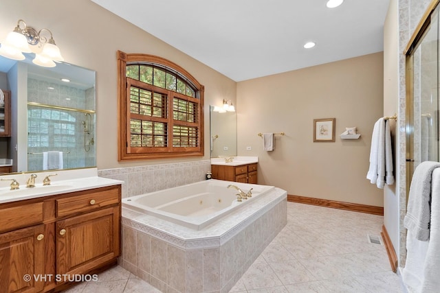 bathroom with a sink, tile patterned floors, a jetted tub, a shower stall, and two vanities
