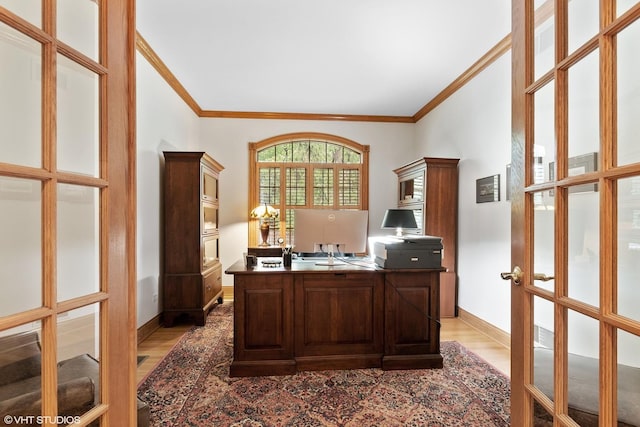 office area featuring baseboards, ornamental molding, french doors, and light wood-type flooring