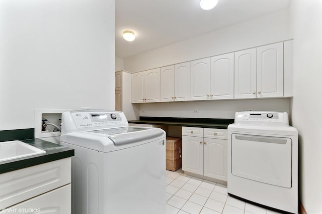 laundry room with cabinet space, washing machine and clothes dryer, and light tile patterned flooring