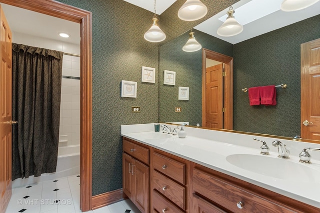 full bath featuring double vanity, shower / tub combo with curtain, tile patterned flooring, and a sink