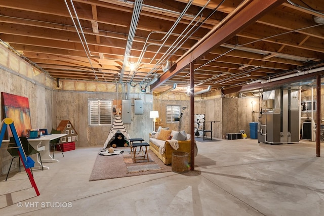 unfinished basement with heating unit and electric panel