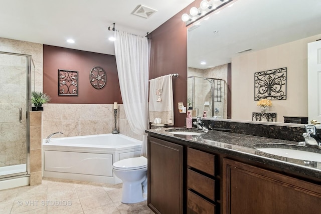 bathroom featuring a sink, a shower stall, a bath, and visible vents