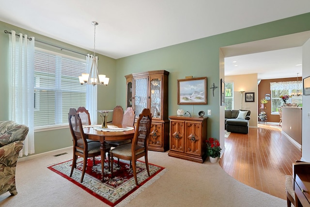 12951 Bull Ridge Dr, Huntley, IL 60142 - dining area featuring visible vents, baseboards, a chandelier, and light wood-style floors