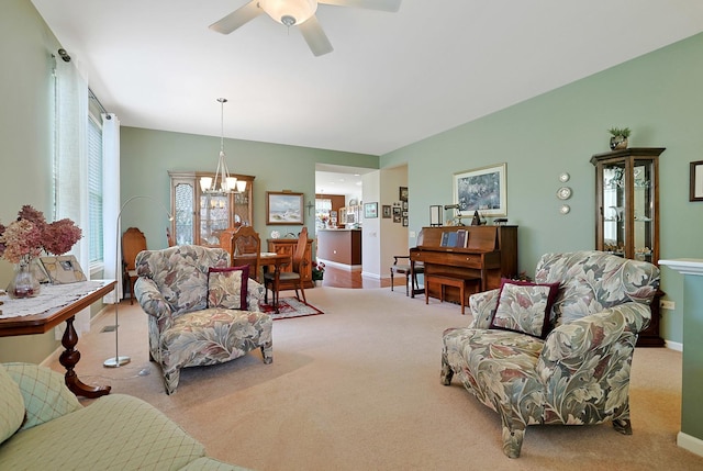 12951 Bull Ridge Dr, Huntley, IL 60142 - carpeted living room with baseboards and ceiling fan with notable chandelier