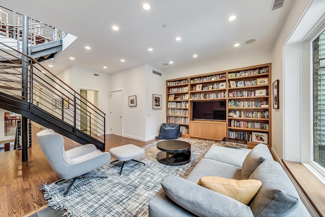 living room with stairs, recessed lighting, baseboards, wood finished floors, and visible vents