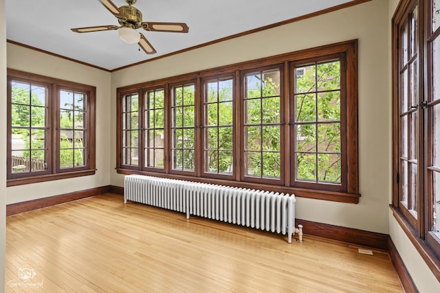 unfurnished sunroom with french doors and radiator heating unit