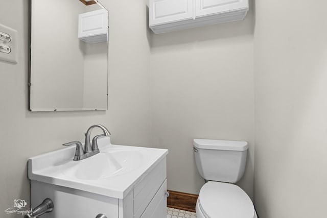half bath featuring toilet and vanity