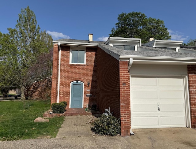 2004 Bruce Dr Unit 1, Urbana, IL 61801 - view of front of home featuring a garage, brick siding, a front yard, a shingled roof, and concrete driveway