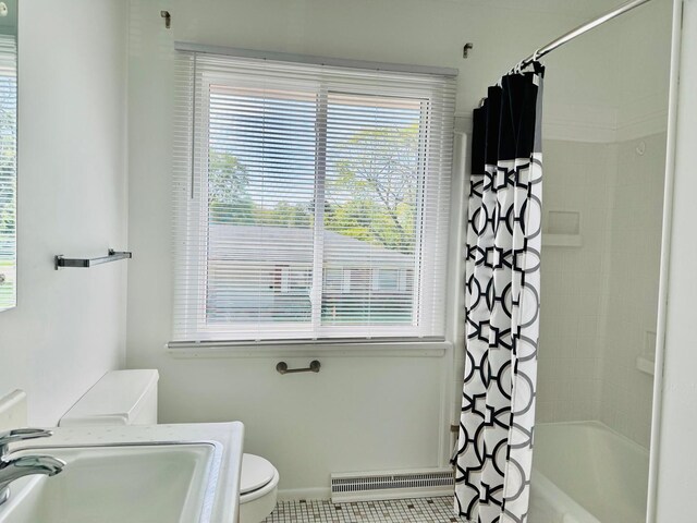 2004 Bruce Dr Unit 1, Urbana, IL 61801 - bathroom featuring toilet, a baseboard heating unit, shower / tub combo with curtain, a sink, and baseboards