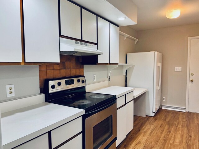 2004 Bruce Dr Unit 1, Urbana, IL 61801 - kitchen featuring stainless steel range with electric cooktop, under cabinet range hood, freestanding refrigerator, light countertops, and white cabinets