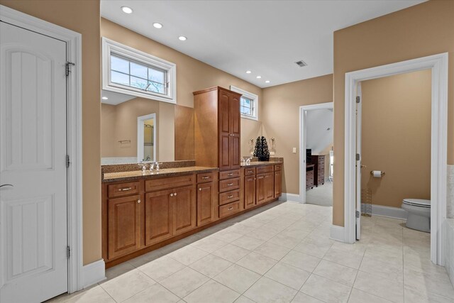full bathroom with vanity, toilet, tile patterned floors, recessed lighting, and baseboards