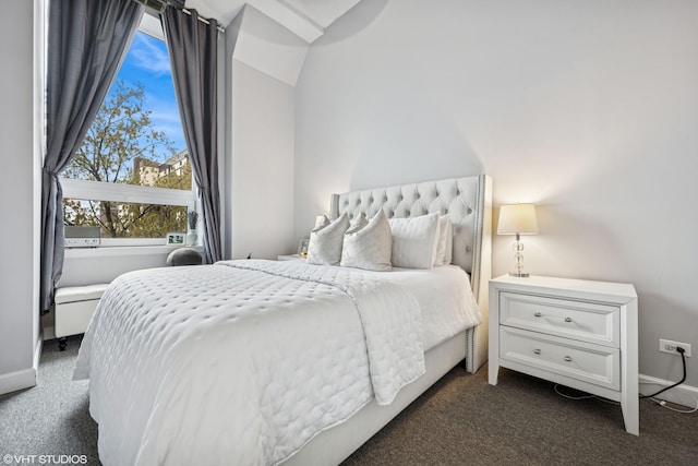 bedroom with baseboards and dark carpet