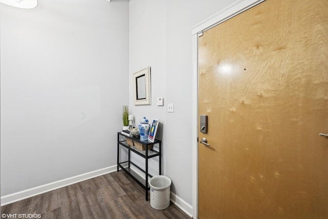 hall with baseboards and dark wood-style floors