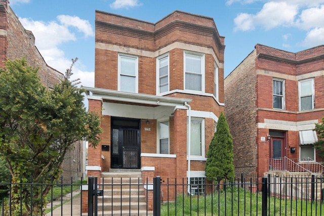 1752 E 72nd Pl, Chicago, IL 60649 - view of front of home with brick siding, a fenced front yard, and a gate