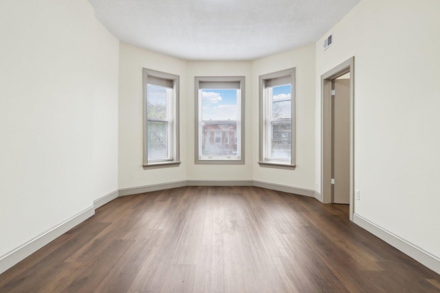 1752 E 72nd Pl, Chicago, IL 60649 - unfurnished room featuring dark wood-type flooring and baseboards