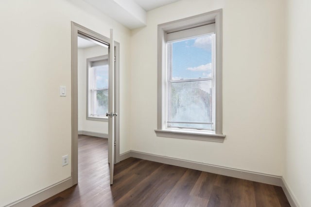 1752 E 72nd Pl, Chicago, IL 60649 - spare room featuring dark wood-type flooring and baseboards