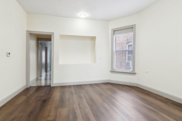 1752 E 72nd Pl, Chicago, IL 60649 - empty room featuring dark wood-type flooring and baseboards