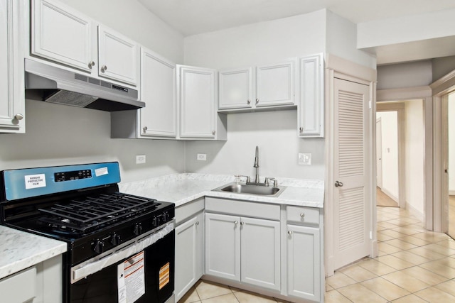 1752 E 72nd Pl, Chicago, IL 60649 - kitchen with stainless steel gas range oven, under cabinet range hood, a sink, light tile patterned floors, and light countertops