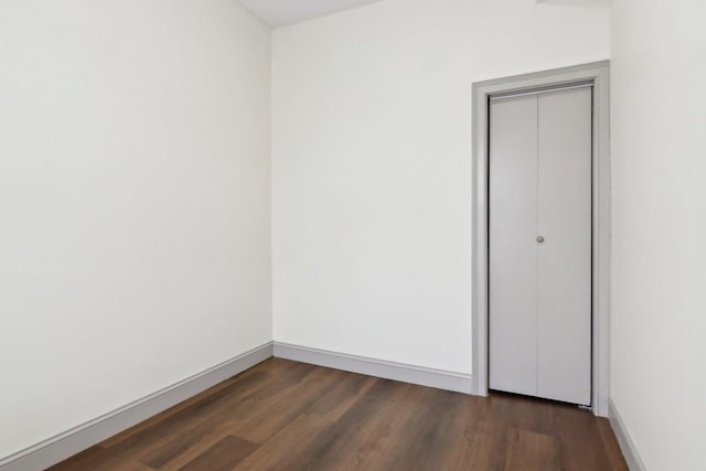 1752 E 72nd Pl, Chicago, IL 60649 - spare room featuring dark wood-style floors and baseboards