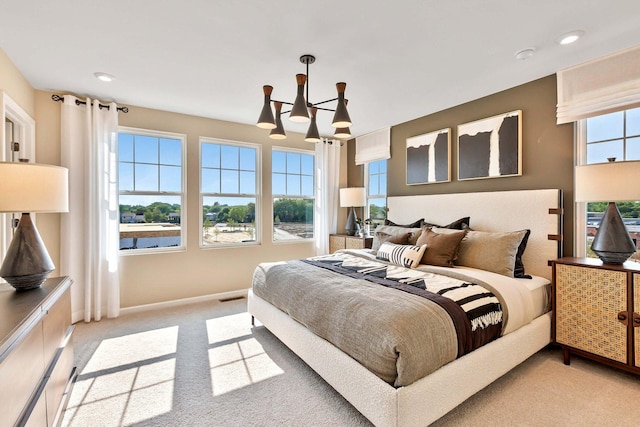 bedroom with visible vents, baseboards, light colored carpet, recessed lighting, and a notable chandelier