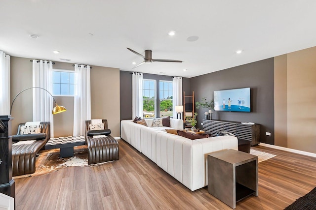 living area featuring a ceiling fan, baseboards, recessed lighting, and wood finished floors