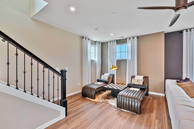 living area featuring recessed lighting, baseboards, and wood finished floors