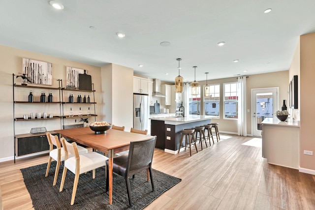 dining room featuring recessed lighting, baseboards, and light wood-style flooring