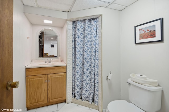 bathroom featuring toilet, a shower with curtain, tile patterned floors, and vanity