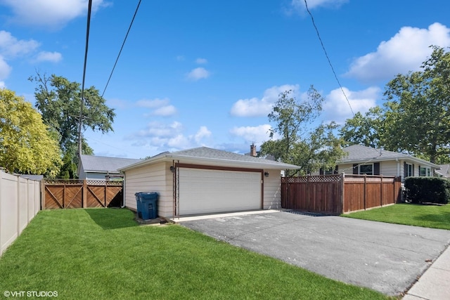 exterior space with a yard, fence private yard, and a garage
