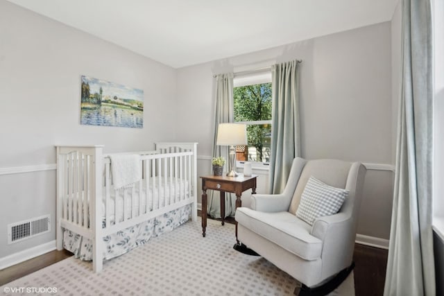 bedroom featuring baseboards and visible vents